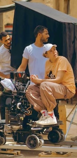 Mai Barakat on camera dolly with crew on location